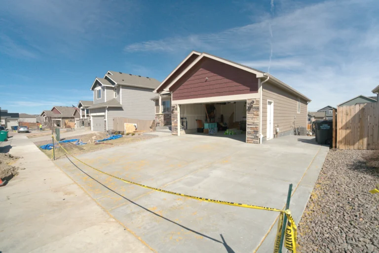 New concrete driveway installation at residential home in Colorado Springs CO by Fort August Construction.