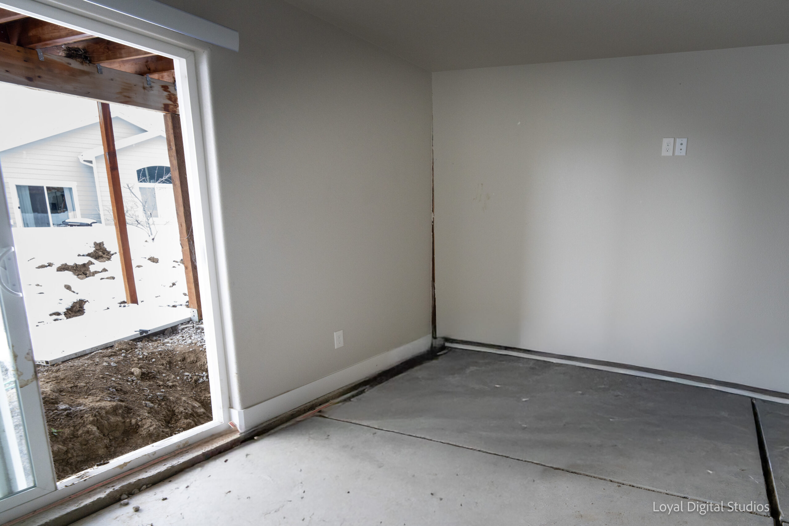 Interior room showing floor and wall separation caused by foundation settlement in a Colorado home.