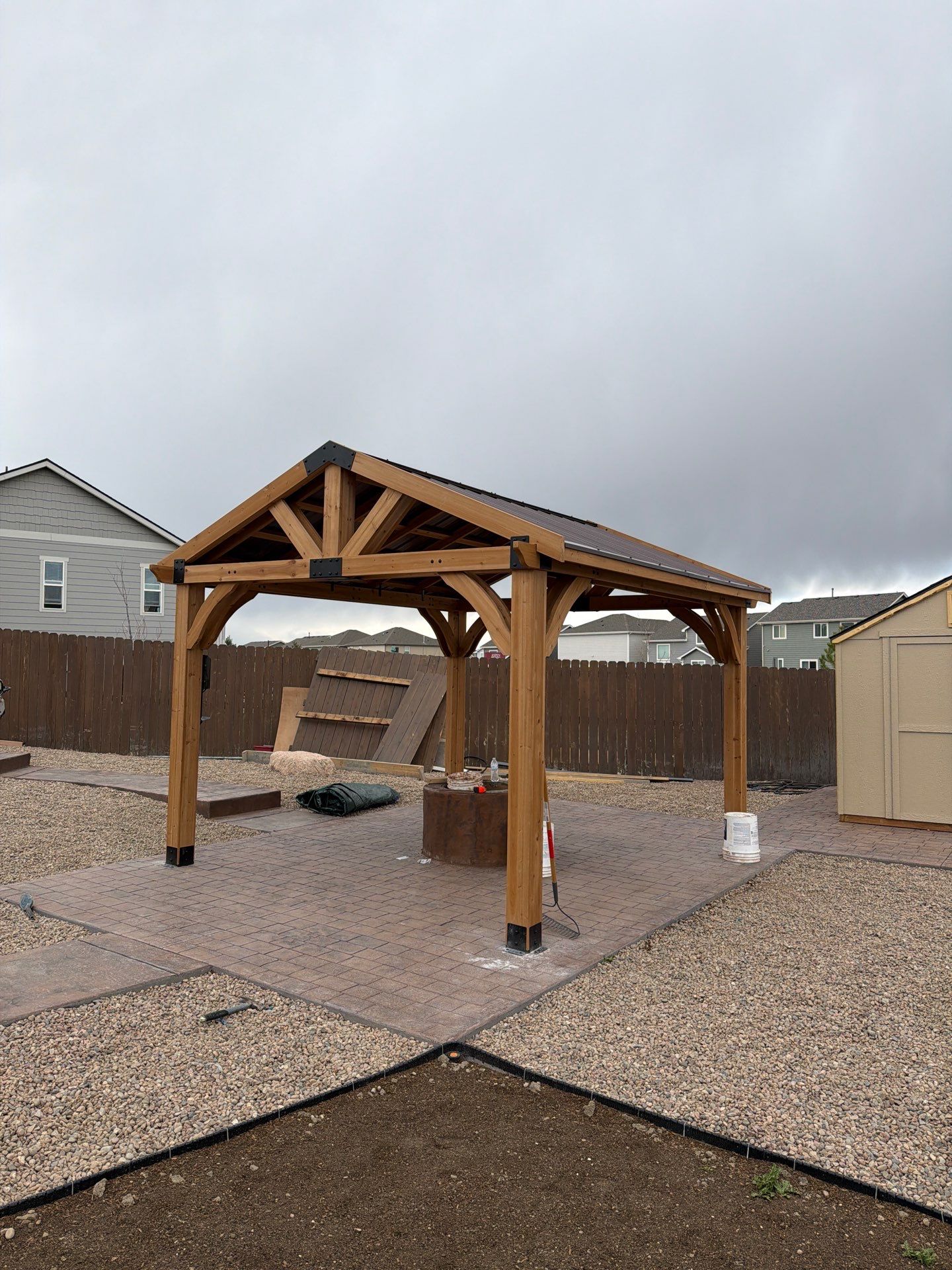 Stamped concrete patio with new pergola installation in Colorado Springs Colorado by Fort August Foundation