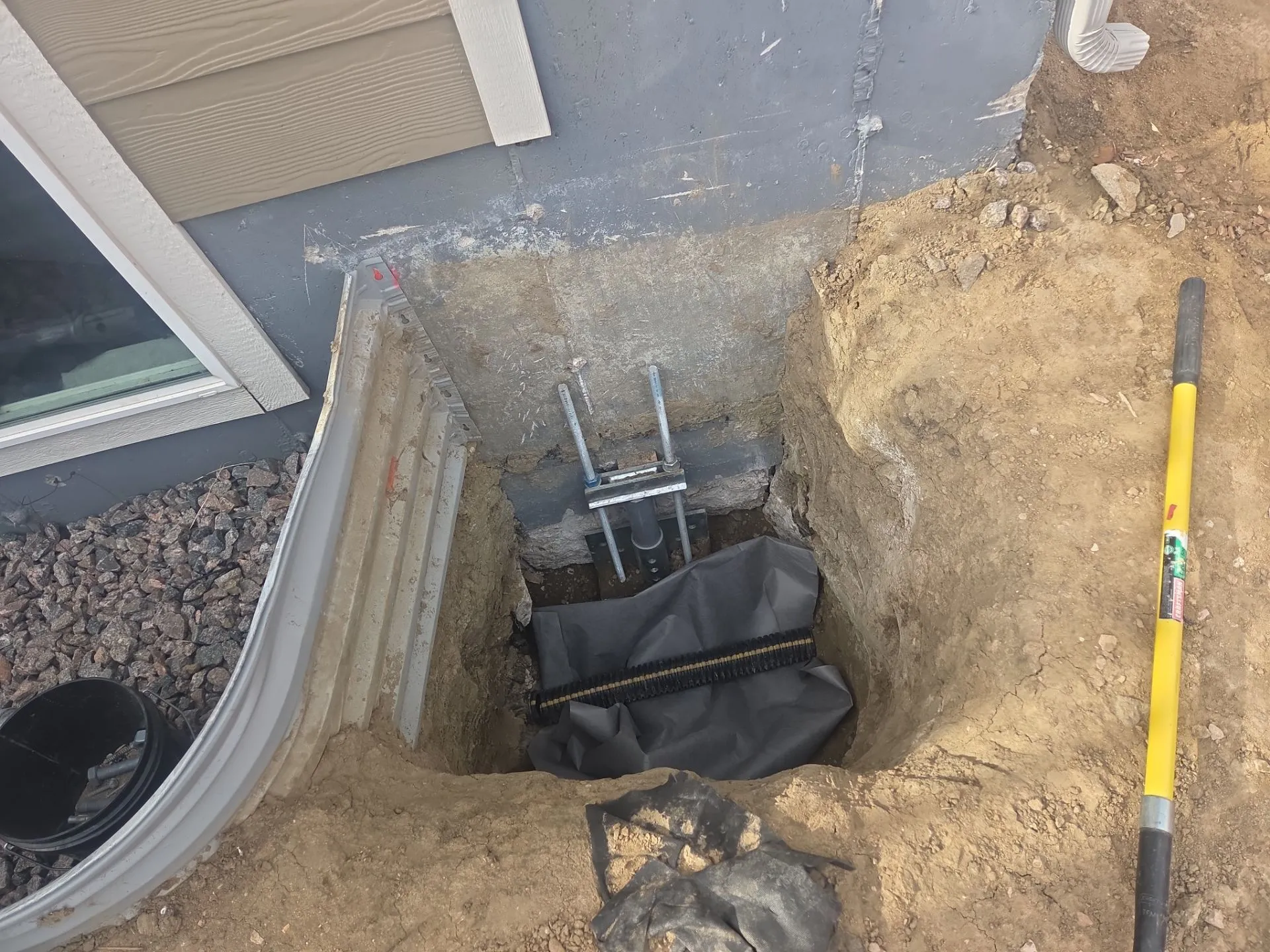 Helical pier installation in Colorado Springs Colorado by Fort August Foundation for foundation stabilization and settlement repair.