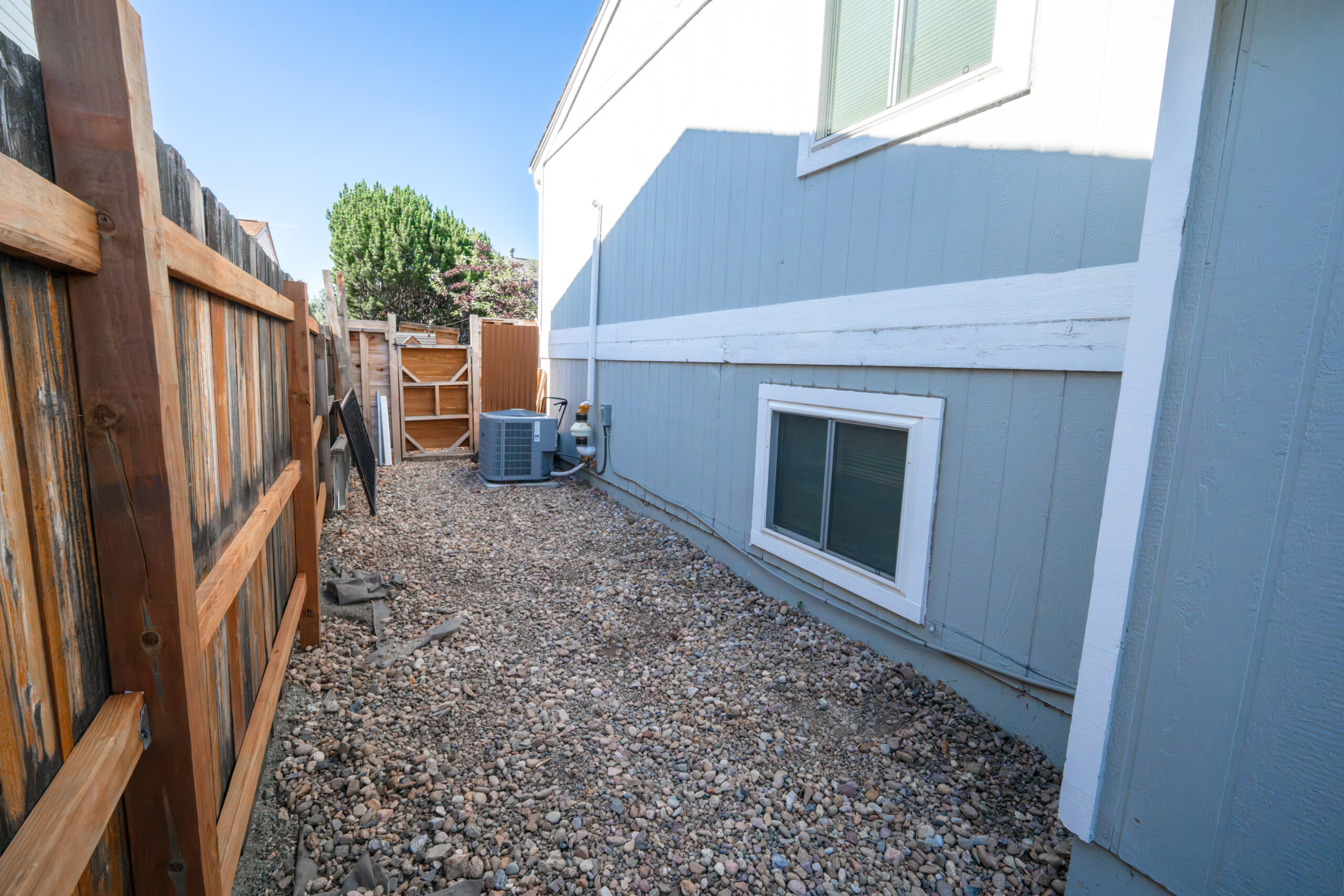 Existing basement window before egress door installation and foundation wall modification in Colorado.