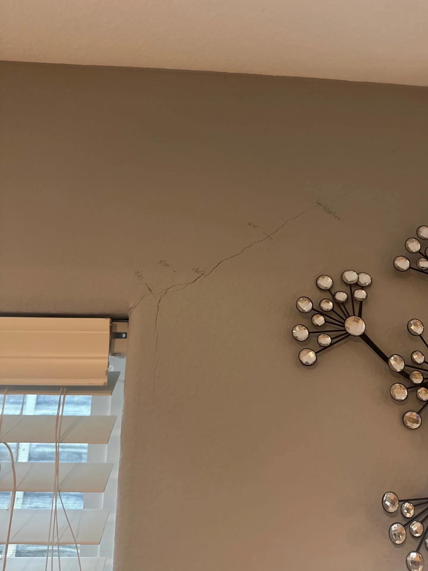 Crack in drywall due to a sinking foundation found during foundation inspection by Fort August Foundation