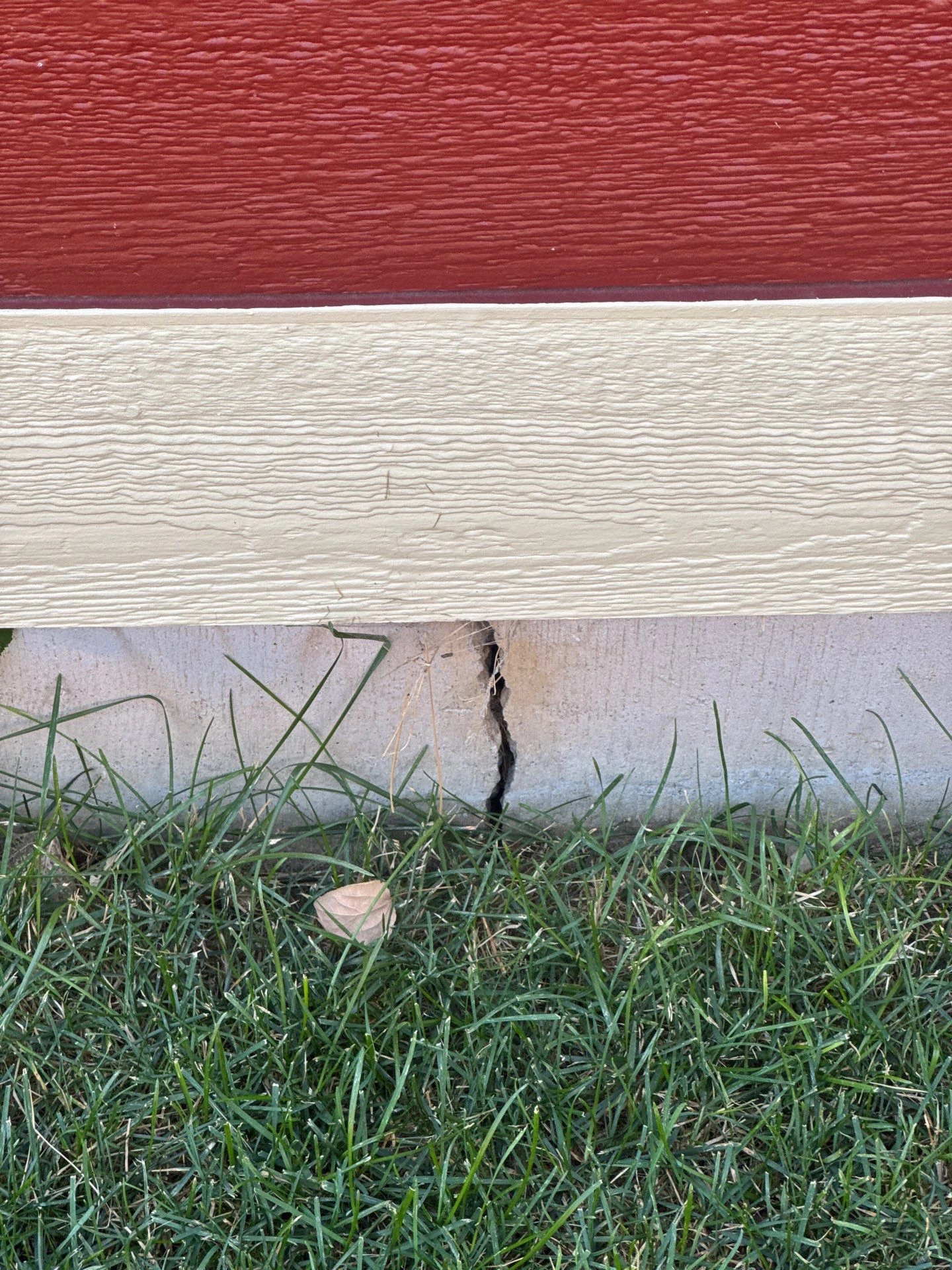 Vertical crack in an exterior concrete foundation documented during a foundation inspection in Longmont by Fort August Foundation