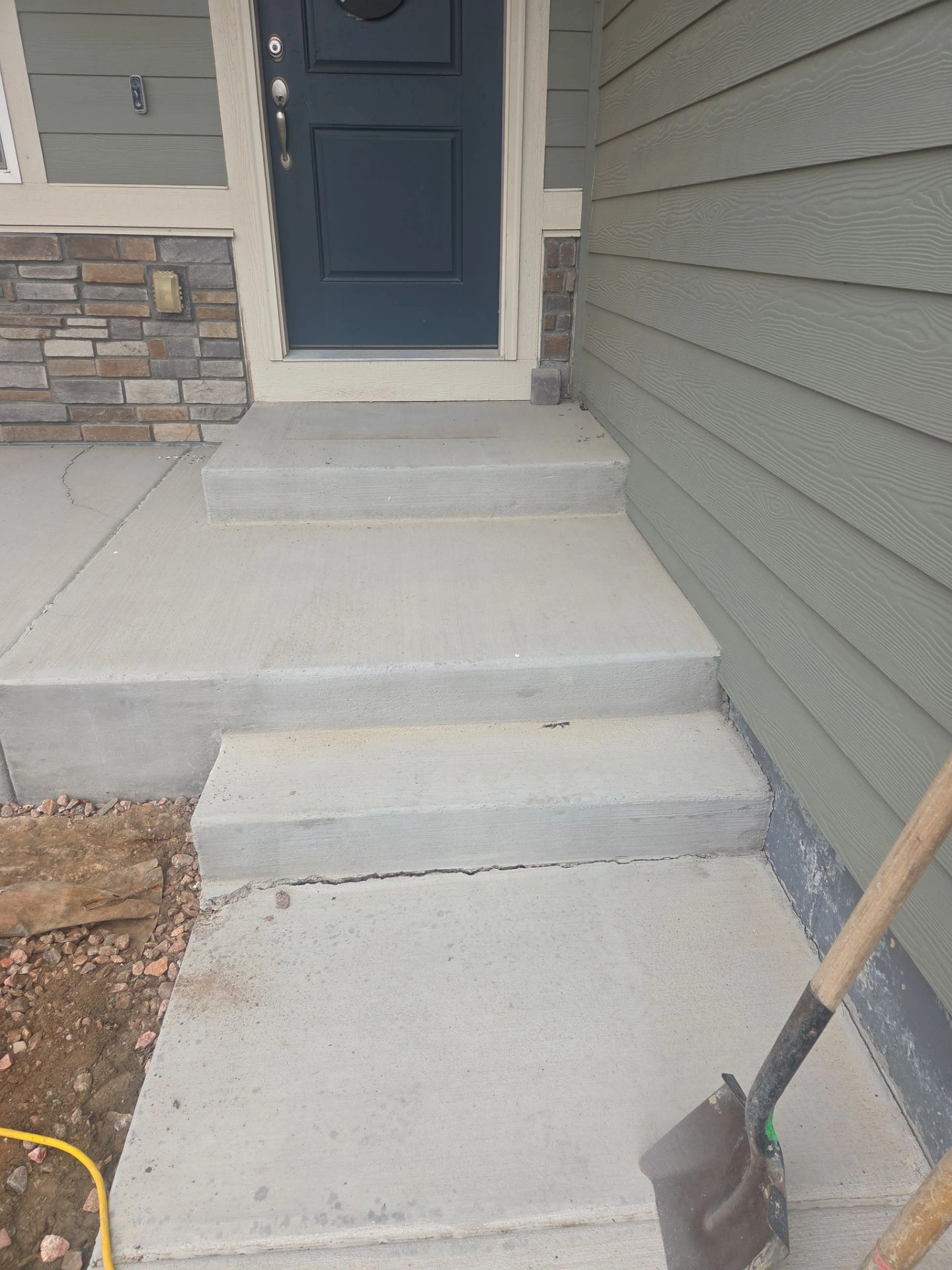Concrete front steps and entry landing during foundation lifting and concrete leveling work by Fort August Foundation in Colorado Springs