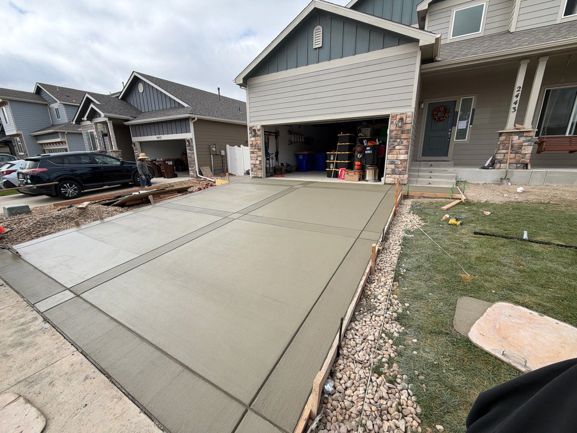 Fresh concrete driveway with control joints and edge forms during installation by Fort August Foundation in Berthoud